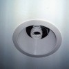 Recessed ceiling light with energy saver bulb in basement remodel  of home on Bradley Boulevard in Bethesda, MD.