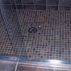 1” tile for shower base with drain and glass sliding doors in home on Bradley Boulevard in Bethesda, MD.