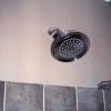 Shower head and close up of 1” tile band in home on Bradley Boulevard in Bethesda, MD.
